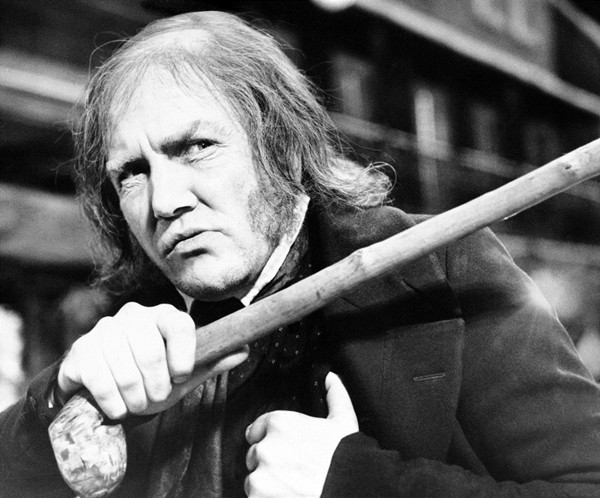 In this Jan. 15, 1970 file photo, British actor Albert Finney waves his cane while playing the title role in “Scrooge,” at Shepperton Studios. (AP Photo/R. Dear)