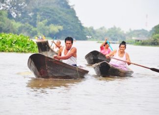 Local people row out from their flooded homes to receive some aid.