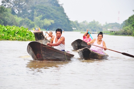 Local people row out from their flooded homes to receive some aid.