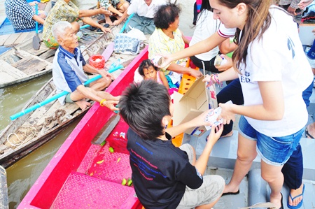 Francesca and Dominic distribute food packets to the local people.