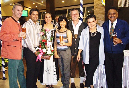 Tony Malhotra (2nd left), sales and marketing manager of Pattaya Mail Media Group, presents a flower bouquet to Kanpitcha Kongsombat (3rd left), executive director of Danmark Co., Ltd., on the grand opening of Paulanergarten. Also on hand were (from left) Ingo Räuber, general manager Pinnacle Resorts, Sue K., director of communication Pattaya Mail TV, Kenneth Whitty, managing director of Danmark Co., Ltd., Earth Saiswang, director PR and communication Oasis Spa, and Peter Malhotra, managing director of Pattaya Mail Media group.