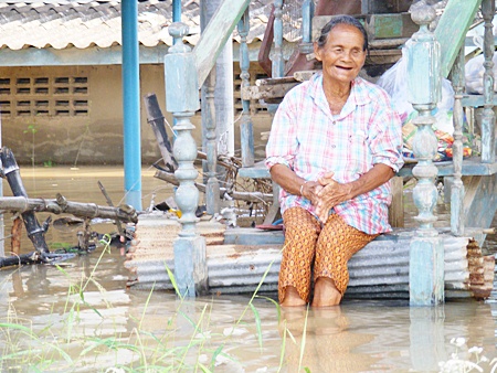 Grandma keeps smiling even though water floods her home.