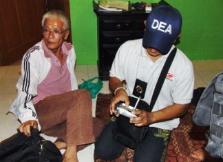 Police search Isao Handa’s (left) belongings after arresting him for allegedly abusing a 13-year-old boy.