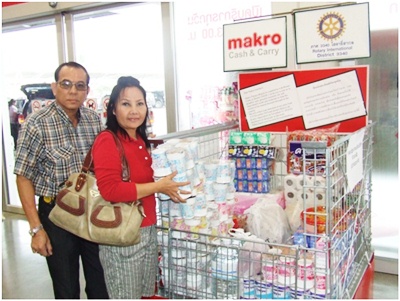 A benevolent couple places packets of foodstuffs in the collection area at Makro Pattaya Branch, for distribution to victims of the floods in the country. 
