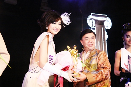 Ami Takeuchi from Japan receives the 1st runner up trophy from Pageant Chairman Dr. Seree Wongmontha.