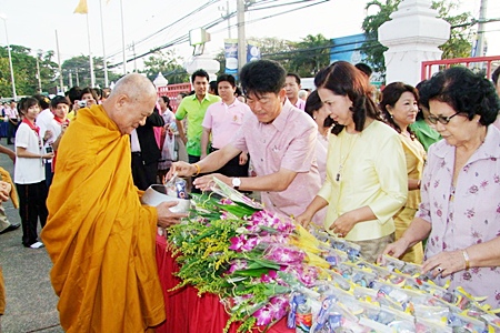 Chonburi Governor Wichit Chatpaisit, along with family, friends and constituents present alms to local monks.