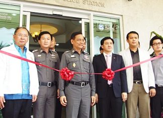 Officials prepare to cut the ribbon on the new police public-service booth.