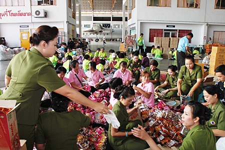 Volunteers help pack bags of relief supplies to send to flood stricken areas throughout Thailand. 