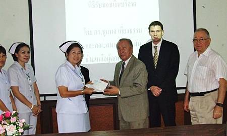 (L to R) Banglamung Hospital Nursing Chief Thepin Inket receives donated funds from Chumpol Thiengtham of the German Benevolent Society of Thailand, Mark Sonntag, managing director Euro Thai Media Co., Ltd, and Horst Schumn. 