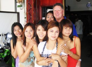 Neville Scurrell, right rear, celebrates his win with the staff at Mama’s Bar.