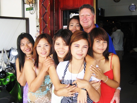 Neville Scurrell, right rear, celebrates his win with the staff at Mama’s Bar.