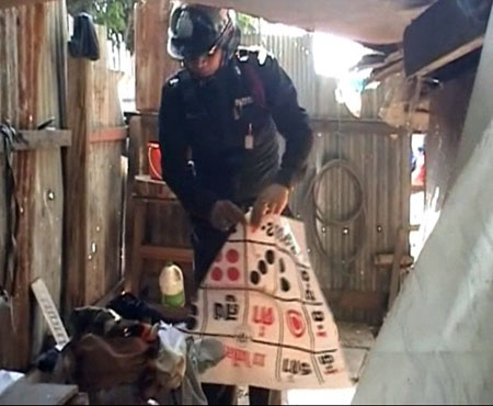 Police Descend on Gambling Den