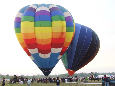 Colorful balloons prepare for takeoff.