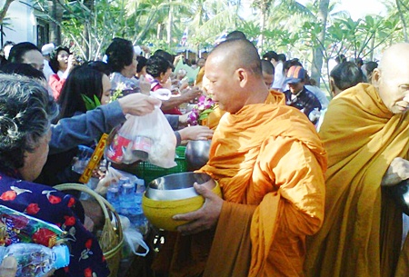 Naklua people present alms to monks.
