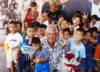 Danish singing legend Johny Reimer, center, a longtime supporter of the Pattaya Orphanage, enjoys a tremendous reception from the kids on his well received return visit.