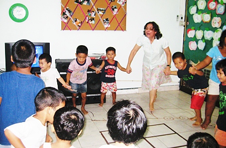 Teacher Margaret joins with the fun at the Hand to Hand center.