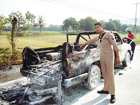 Sgt. Nattapol Khatsai points to what used to be his dependable pickup truck.
