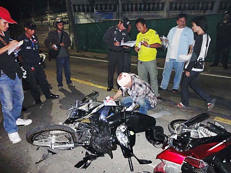 German Quarz Gunter retrieves paperwork from his demolished motorcycle after the fatal crash. 