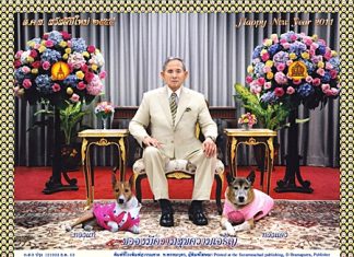 His Majesty the King, shown here with his dogs, Tongdaeng on his left and Tongthae on his right - says we all have the same New Year’s wish - to be happy and to progress in life.