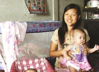 19-year-old Parawee Phoram and her triplets, two out front and one in the crib.