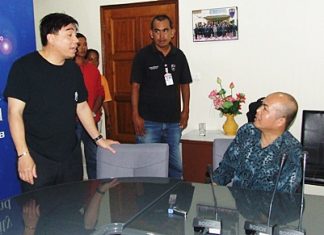 Prayong Nuanchawee (seated) has been charged with human trafficking of minors, managing a den of prostitution, child abuse, allowing minors into a venue where alcohol is served and employing underage workers.