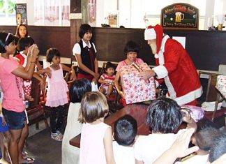 Jolly Ol’ St. Nick hands out gifts to the excited Ban Jing Jai residents.