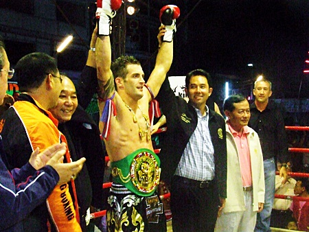 England’s Steve Wakeling has his arms raised by Pattaya Mayor Ittiphol Khunplome, right, and Gen. Kovid Bhakdibhumi, left, after being presented with the WBC belt.