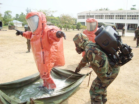 After finding and disposing of the chemical weapons, soldiers are disinfected to ensure no after effects.