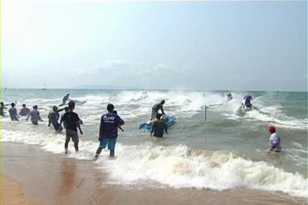Jetski riders crash through the surf at the start of one of the races on Saturday.