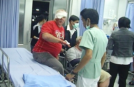 Russian tourists Vladimir Tuzo and Nicolai Crostrin are treated by staff at Pattaya Memorial Hospital after being attacked by robbers on Feb. 21.