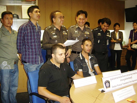 The 2 French nationals, seated, are held for questioning at Pattaya Police Station.