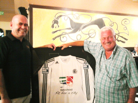 Stewart Fraser of Shenanigans Irish Bar in Jomtien, left, is seen with former Gateshead goalkeeper George Alberts, who lives in Thailand, with a backdrop of a framed Gateshead Football Club shirt brought over by Laurence Dinning one of the club’s sponsors.  Gateshead, who are currently members of The National Conference league in England, are two games away from a Wembley appearance in The FA Trophy.  George, who played under two managers at Gateshead in the 1960’s (former Newcastle winger Bobby Mitchell, and George Hardwick of England and Middlesbrough) was delighted with the presentation and remarked that another former Gateshead player Tom Callender, who played 432 games for Gateshead in the old 3rd Division (North), had once been described by the late Nat Lofthouse as one of the best centre half’s he had played against.  Bolton beat Gateshead 1-0 in an FA Cup 6th round tie in 1953 on their way to the final against Blackpool. 