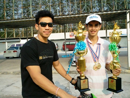 Ben, right, is awarded his overall winners’ trophies by tennis star Paradorn Srichaphan.
