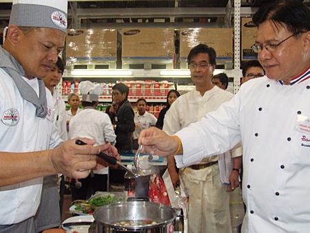 Chef Booncherd Sornsuwan (right) takes an early taste test of one of the contestant’s creations.