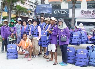 A handful of Korean tourists model the new life jackets as tour employees prepare to hand out hundreds of the safety devices during the day.