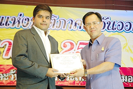 Suwanthep Malhotra Pattaya Mail’s Assistant MD (left) receives the prestigious “Most Outstanding Mass Media of the Year” plaque from Chonburi Vice Governor Pongsak Preechawit.