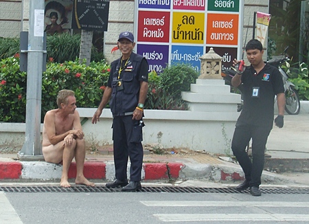 Volunteers try to persuade the naked man to dress. 
