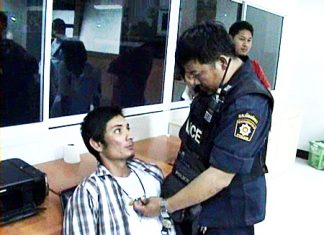 Finlip Kongnoi, seated, is held for questioning at Pattaya Police Station, Tuesday, March 1.