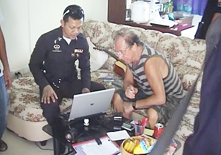 Police check Karstein Abrahamsen’s laptop computer for any incriminating evidence following his arrest at the K2M Apartments in Pattaya on Tuesday, March 1.