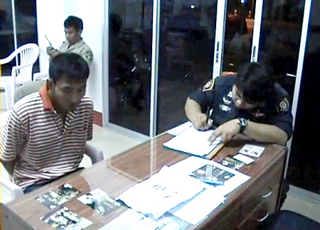 Niwat Suda, left, helps police with their enquires after being arrested on Wednesday, March 2.