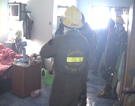 Firefighters clear up after dousing the fire at the R-Con Apartments on Soi Doodee last Thursday.