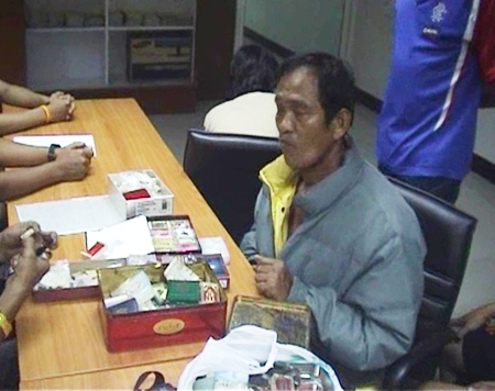 Lilai Piansu checks an inventory of the Buddhist amulets with Pattaya police.