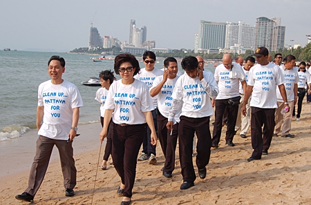 Vasana Khwanmuang, 3rd left, leads volunteers on a beach cleaning exercise on Monday, March 14.