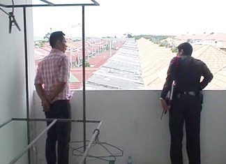 A police officer checks the rooftop where the thieves apparently entered the building.