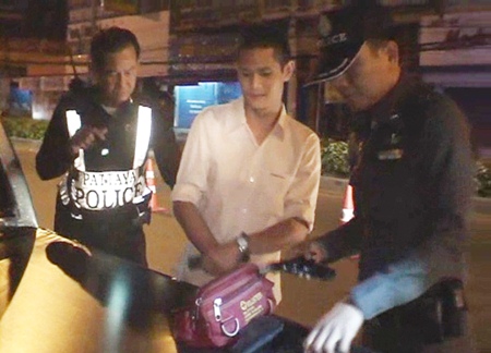 Komsan Sima, center, is arrested for illegal firearm possession.