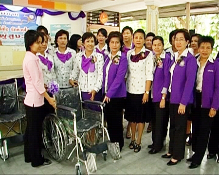 Staff from the Provincial Electric Authority present wheelchairs and other supplies to the Banglamung Home for the Elderly.