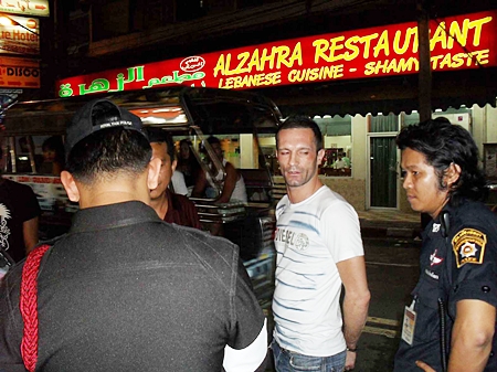 French national Sebastian Gillami is arrested by Pattaya police on Pratamnak Road, Sunday.