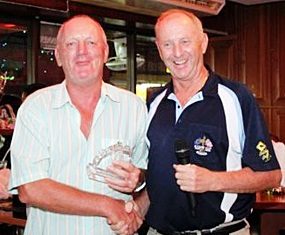 Bob Newell, left, receives his low gross trophy from Lewiinski’s golf manager Colin Davis.
