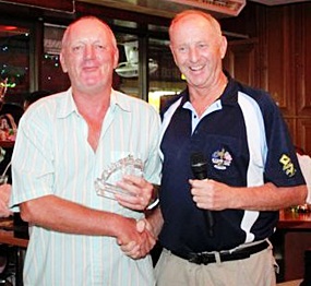 Bob Newell, left, receives his low gross trophy from Lewiinski’s golf manager Colin Davis. 