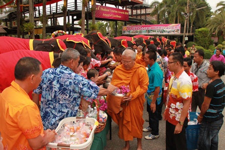 The tourist attraction’s Songkran Festival began early April 13 with 19 elephants giving alms and dried foods to nine monks from area temples.